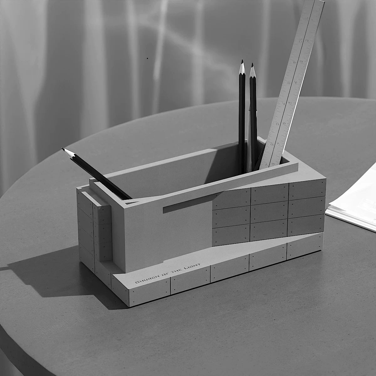 Church of Light organizer holding pencils and a ruler in directional light on a desk.