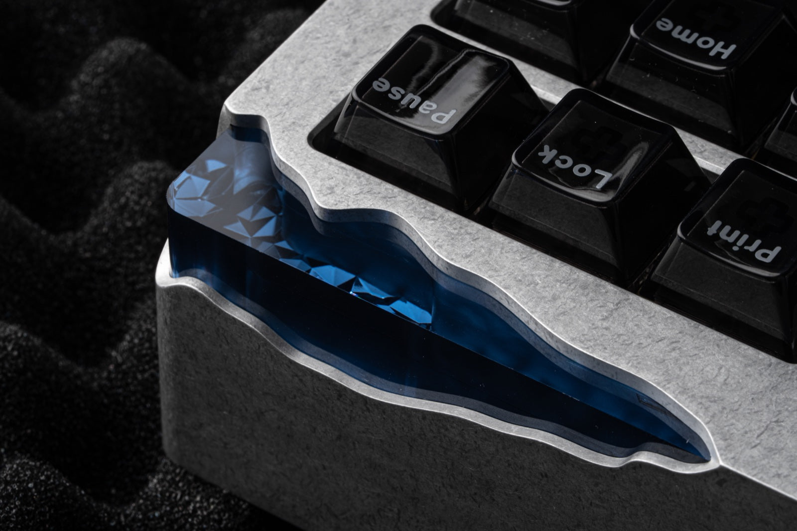 Blue diamond-patterned corner lighting module visible beneath the machined aluminum cutaway.