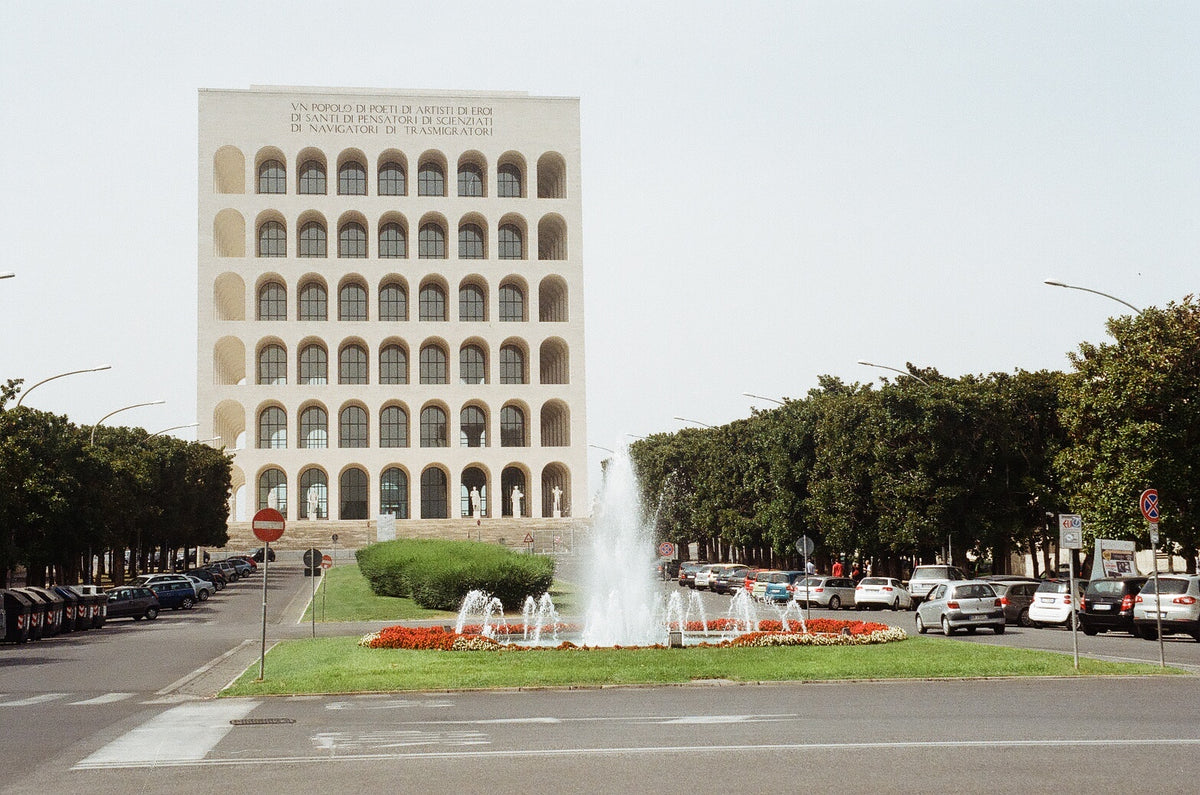 Real exterior of Palazzo della Civiltà Italiana in Rome, showing its cubic form and repeated arches.