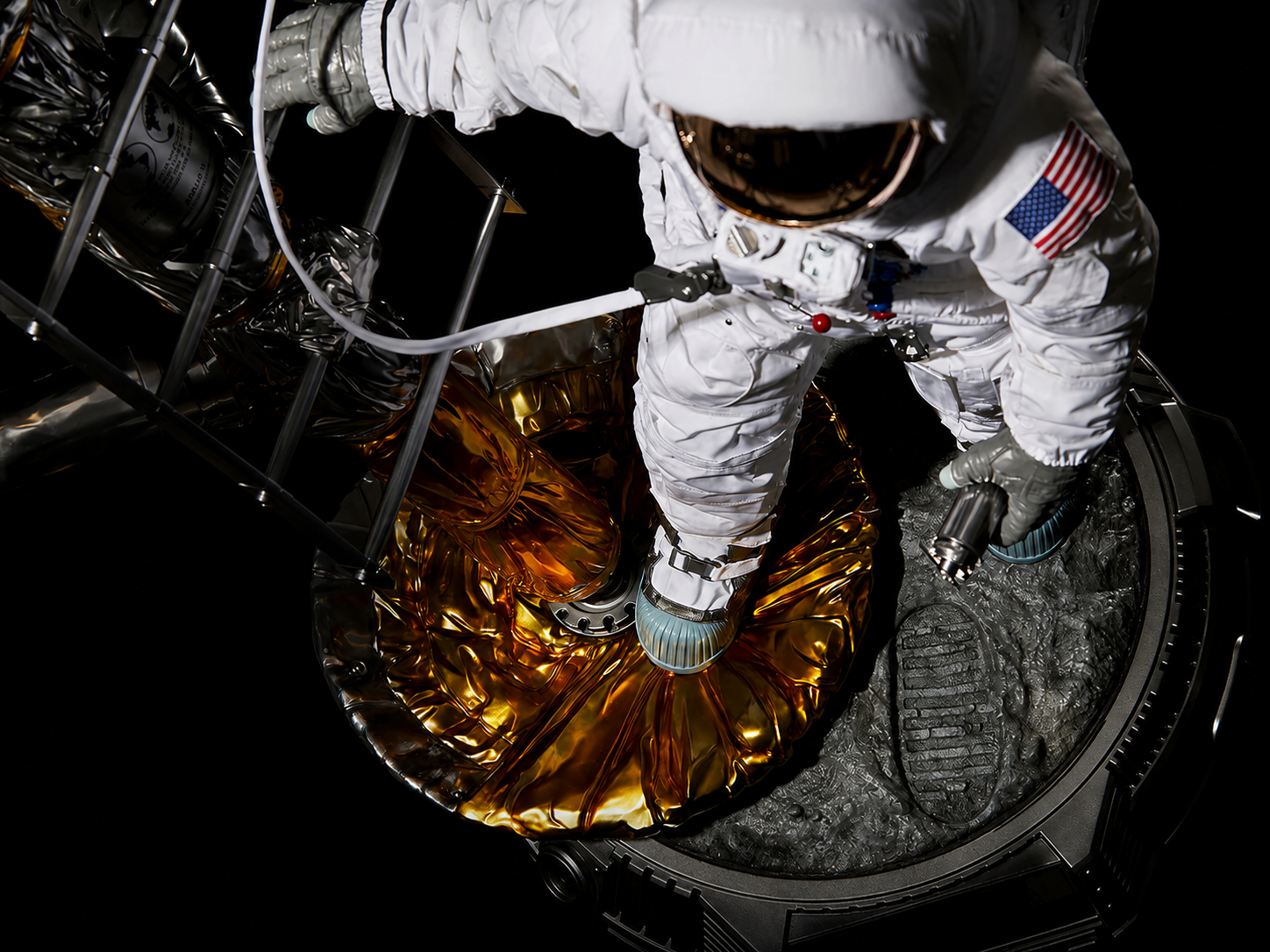 Overhead view of the astronaut, lunar-module landing surface, tether, lunar ground, and footprint.
