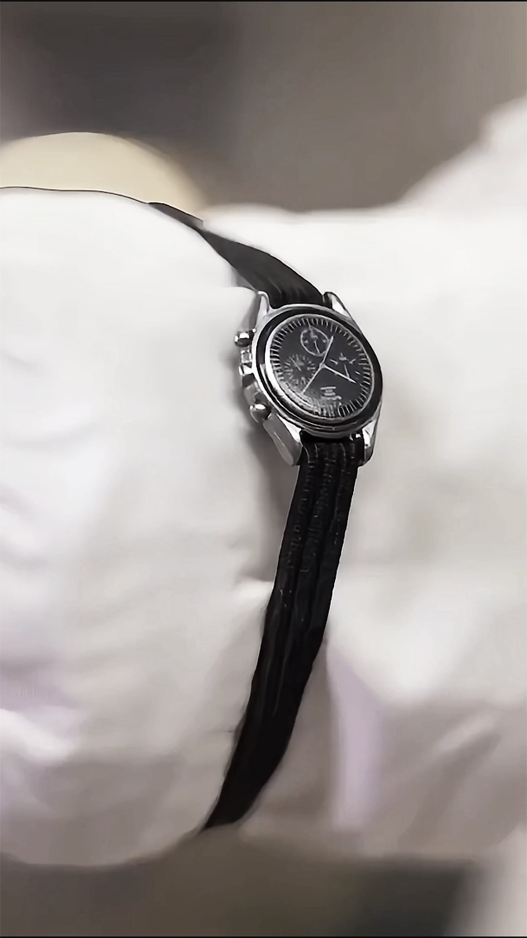 Close view of the miniature Omega Speedmaster fitted over the A7L suit sleeve.