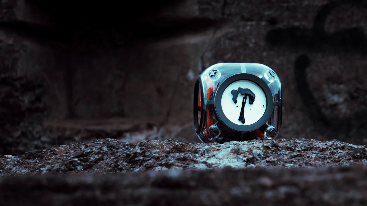 Nebula speaker glowing blue in a rocky environment